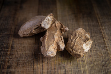 DRIED GINGER ON WOODEN BACKGROUND MACRO SHOT, garam masala herbs
