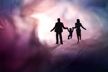 Love and Happy Family. Exploration for Children and Parent. Miniature of Father, Mother and Son holding Hands and Walking on a Mystery Place