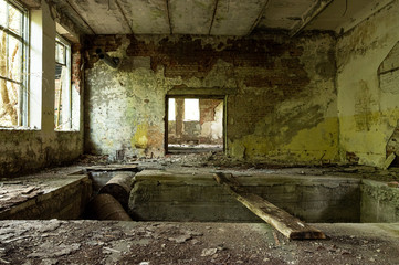 Fototapeta na wymiar Old abandoned production halls. Broken walls and windows.