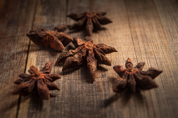 STAR ANISE ON WOODEN BACKGROUND, MACRO PHOTOGRAPHY OF GARAM MASALA ON WOODEN TEXTURE BACKGROUND, 