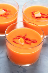 Salmorejo, Spanish cold tomato and bread soup, served in glasses, close-up shot