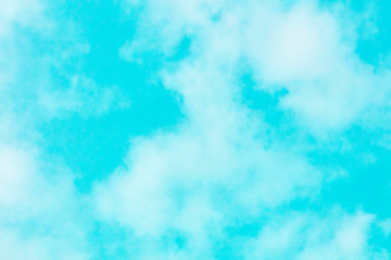 Fototapeta na wymiar Abstract background texture of a vibrant teal blue sky with soft clouds
