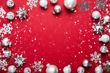 Red Merry Christmas and Happy Holidays greeting card, frame, banner. New Year. Winter holidays. Silver ornaments.