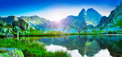 mountain lake in Retezat National Park, Romania. Lens flare added for sun effect