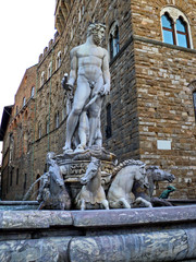 Famous fountain of Neptune in Florence, Italy. Ancient majestic sculpture near old palace (Palazzo Vecchio) on piazza della Signoria. 