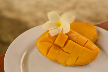 Ripe pieces of fresh mango are on the plate.
