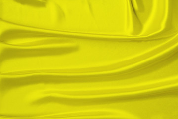 beautiful satin draped with soft folds fabric, silk cloth background, close-up, copy space