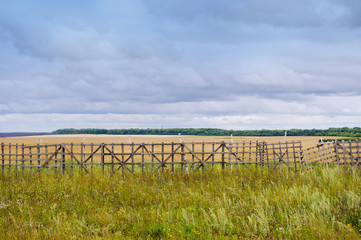 autumn field behind an old wooden fence