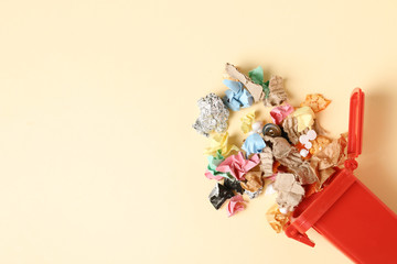 Trash bin and different garbage on color background, top view with space for text. Waste recycling...