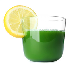Glass of wheat grass juice served with slice of lemon on white background