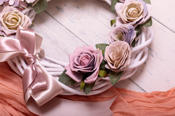 Autumn wreath tied with a burlap bow against a weathered shabbi wooden plank background.