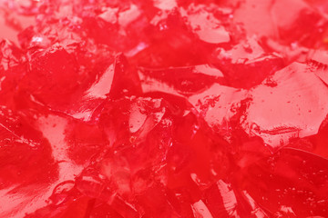 Red tasty fruit jelly as background, closeup