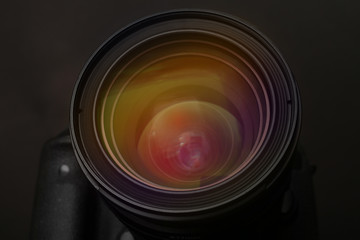 Lens of professional camera on black background, closeup