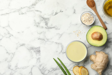 Flat lay composition with handmade face mask and ingredients on marble table. Space for text