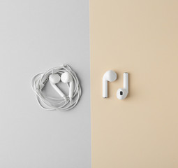 Flat lay composition with different earphones on color background