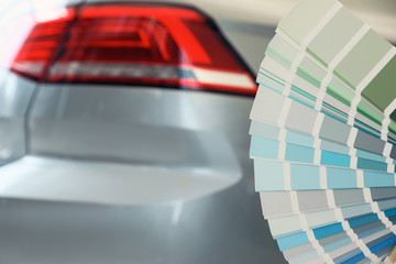 Fototapeta premium Palette with different color samples near modern car, closeup. Space for text