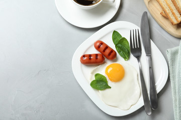 Delicious breakfast with fried egg served on table, flat lay. Space for text