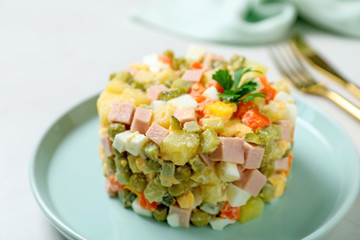 Traditional salad Olivier served on light table