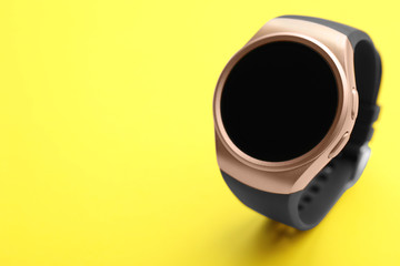 Trendy smart watch on yellow background, space for text