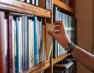 boy picking up book from a bookstore