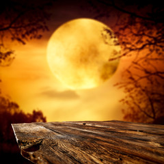 Autumn desk of free space and moon on the sky 