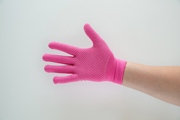Hand in pink nylon gloves.