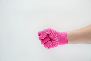 The pink-gloved hand is clenched into a fist on a white background.