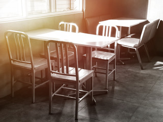 Chairs and table in the empty restaurant.The sun shines into the dining room. Sunlight hits objects