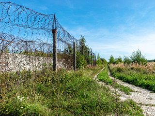 Fragment of barbed wire mounted above prison fence, Rummu quarry, Estonia