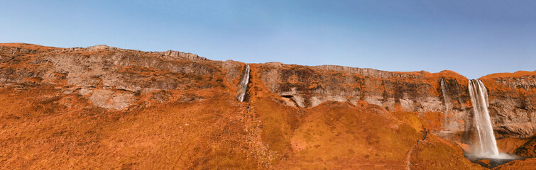 Seljaland Waterfall, aka Seljalandsfoss, panoramic aerial view at summer sunset