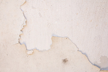 Old cracked paint on the concrete wall. Texture, pattern, background.