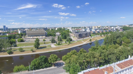 Gediminas Tower of the upper castle in Vilnius with Neris river and modern city skyline, aerial view of Lithuania
