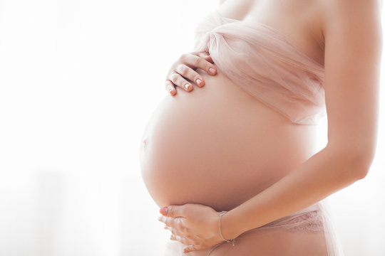 Closeup picture of pegnant woman. Unrecognizable expectant. Belly closeup.