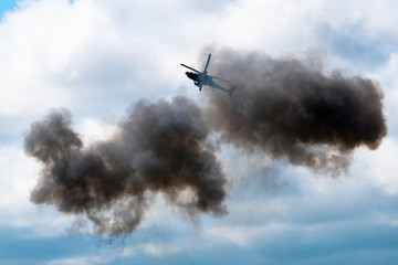 airshow with helicopter coming out of smoke 