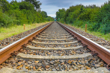 a drone flies in good weather at a very low altitude over railway tracks