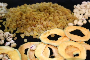 Dried fruit background. Rows of dried dates, apricots,cranberries, pomelos, blueberries, nuts, prunes and figs.
