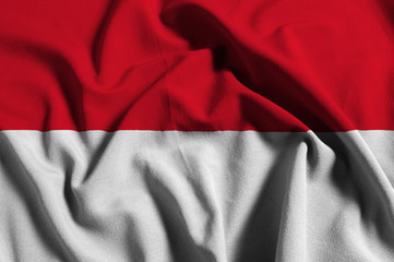 National flag of Indonesia on a waving cotton texture background