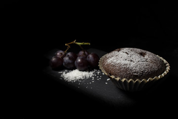 Cocolate muffin with berry filling grapes