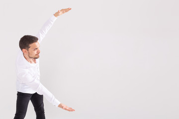 Handsome man with beard pointing in one direction on a white background, copyspace