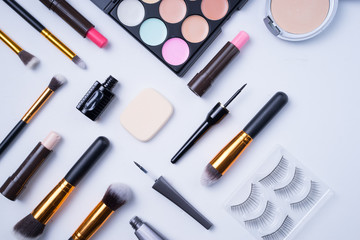 Beauty or cosmetics concept. Creative arrangement of cosmetics on white background. 