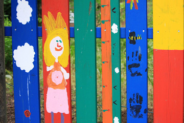 Colored strips of the fence in the yard on the street.