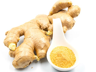 Ginger root and ginger powder in a spoon, isolated on a white background.