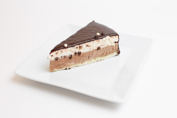 piece of cake on a plate on white background