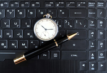 old clock, pen and computer keyboard