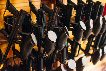 paintball guns hanging on wood background