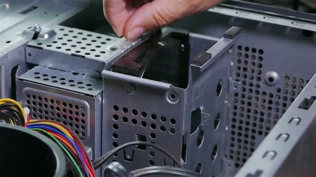 A repairman is removing hard disk from the computer