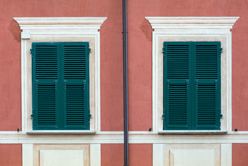 Windows with closed green wooden shutters