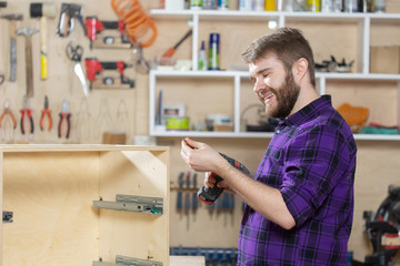 Manufacturing, Small-Sized Companies and worker concept - man working on the furniture factory