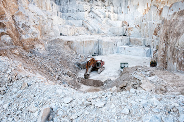 Excavator or digger inside an open cast mining pit