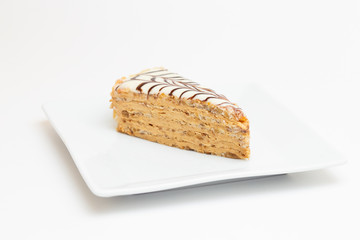 piece of cake on a plate on white background